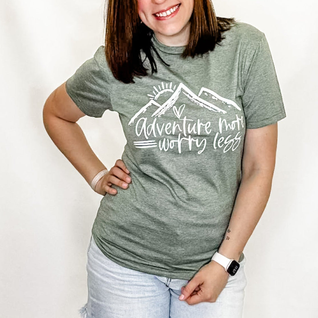 Woman wearing a gray t-shirt with a graphic design on a white background