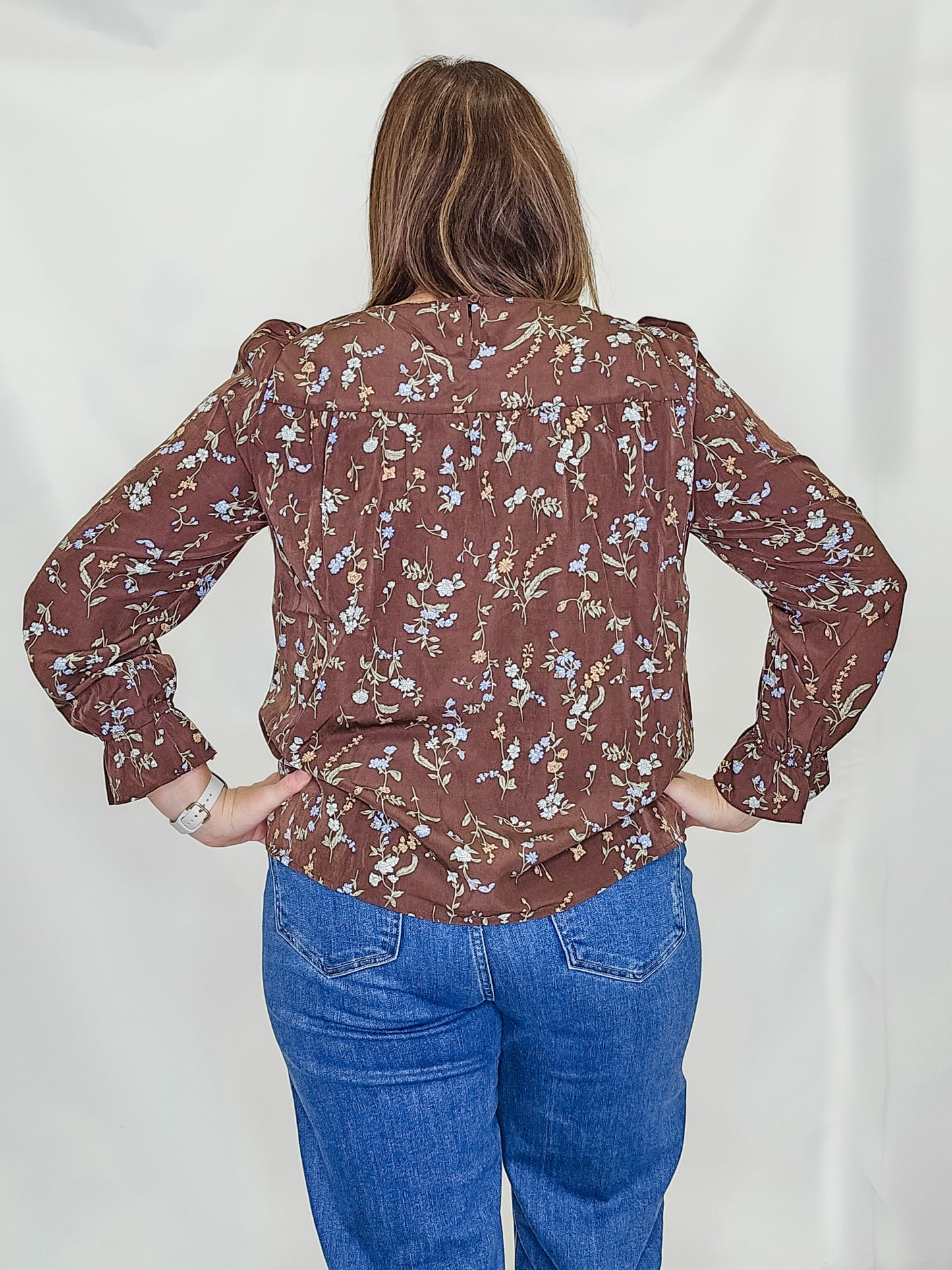Brown Floral Ruffle Hem Top. Back view.