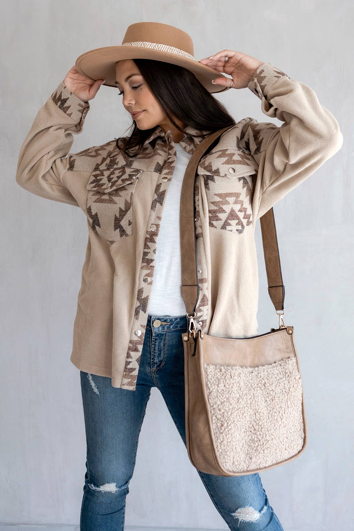 Jen & Co Chloe Teddy Trim Crossbody with Guitar Strap - M1977TED. Taupe. Lifestyle image.