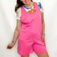 Person wearing a pink outfit with colorful accents on a white background