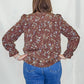 Brown Floral Ruffle Hem Top. Back view.